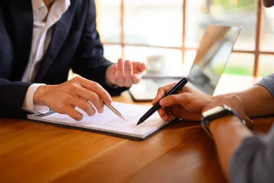Business owner and agent finalizing general liability policy in Destin